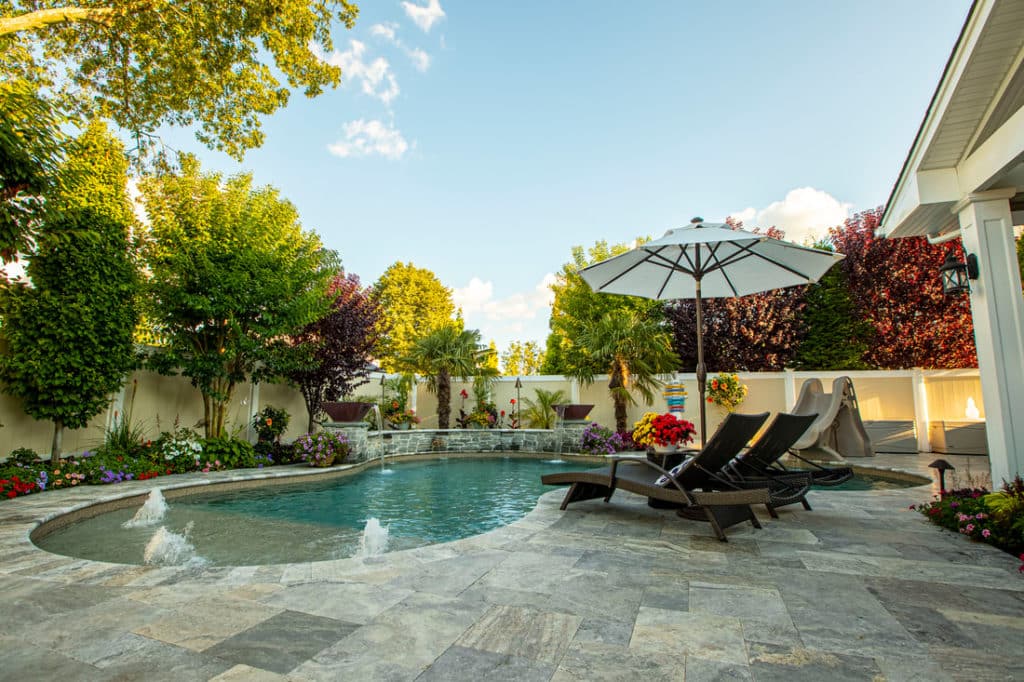 Ronkonkoma, New York - Photo courtesy of Dakota Pools, Inc. - Image Shown: Vinyl Liner Freeform with Spa & Tanning Ledge