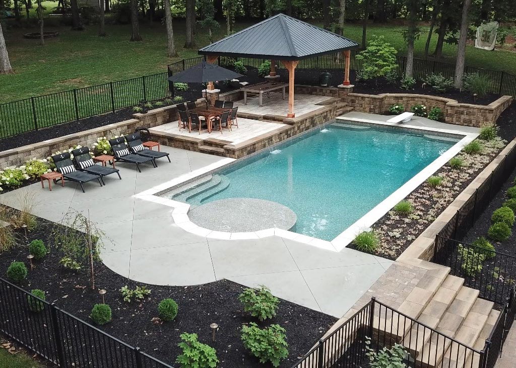 small cocktail vinyl liner pool in backyard with diving board