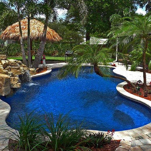 Free-form inground Fiberglass Pool with Hawaiian Landscape and Decor