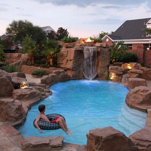 Swimming Pool with rock decor and tall waterfall