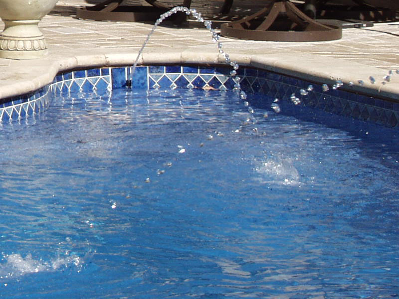 custom tiling for fiberglass pools - pool with jet