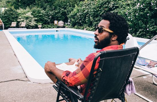 man-near-pool-sunglasses-chair.jpg