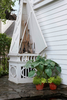 A wooden obelisk for pool equipment storage