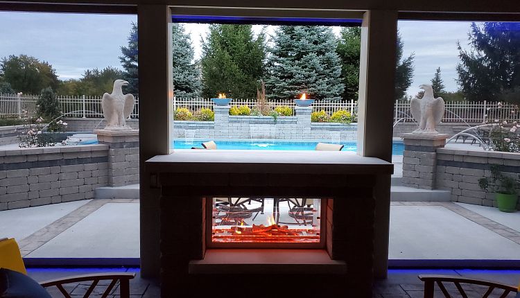 custom pool with enclosed fireplace and raised fire pits
