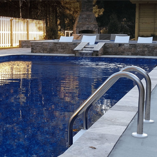 Deep blue inground pool with a swirling, ocean-inspired pattern