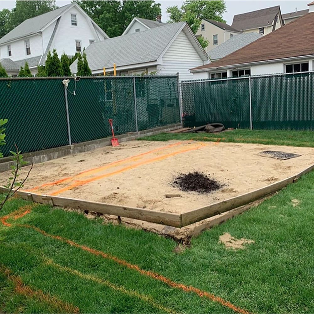 A small yard with a large square sandbox