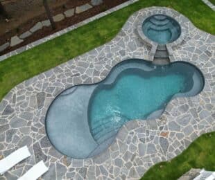 fiberglass freeform shaped inground pool with spa