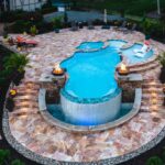 Pennsylvania fiberglass pool with tanning ledge, fire pits, and custom waterfall