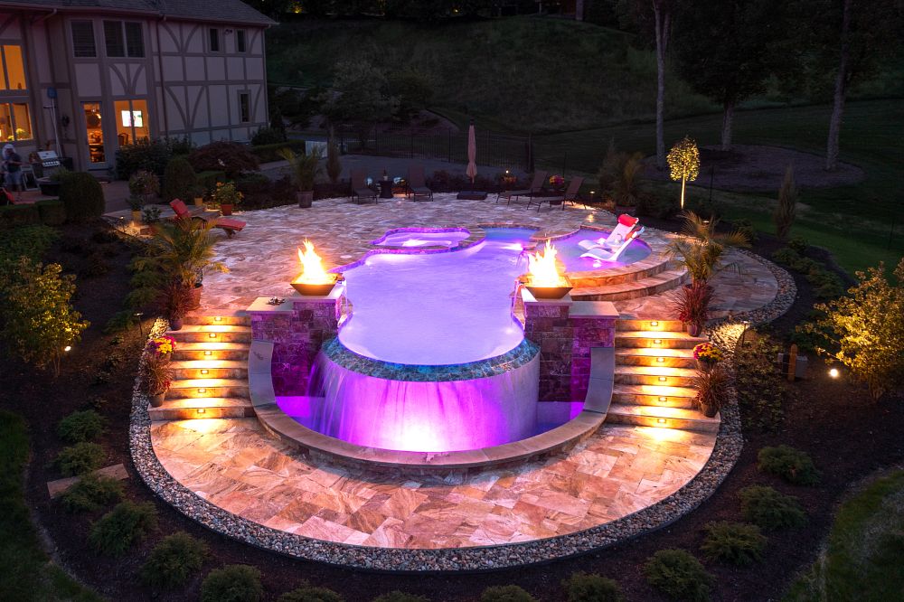 fiberglass pool with custom water features, fire pits, tanning ledge, and spa