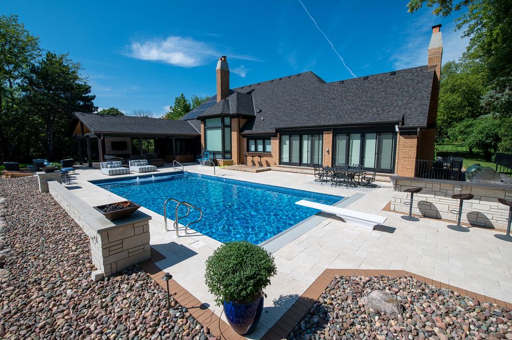 rectangular vinyl liner pool in Illinois backyard with diving board and custom water features