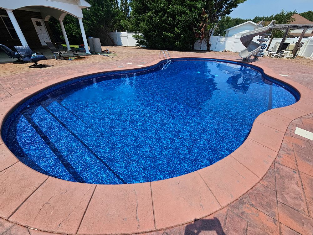 large vinyl liner pool in forested North Carolina backyard