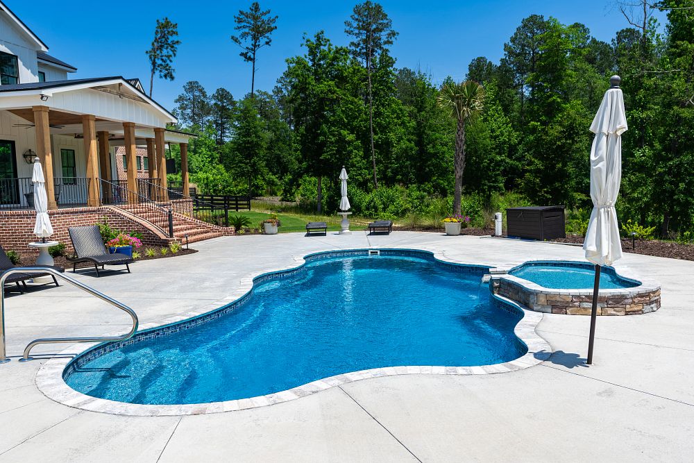 freeform fiberglass pool with spa in large South Carolina backyard