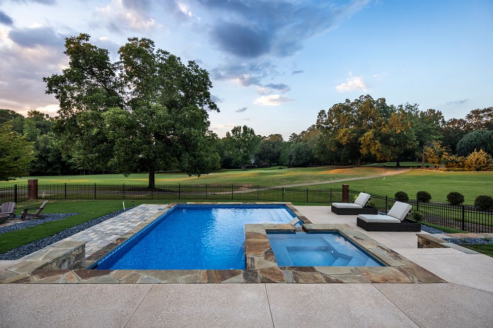 vinyl liner pool and spa in a large fenced backyard
