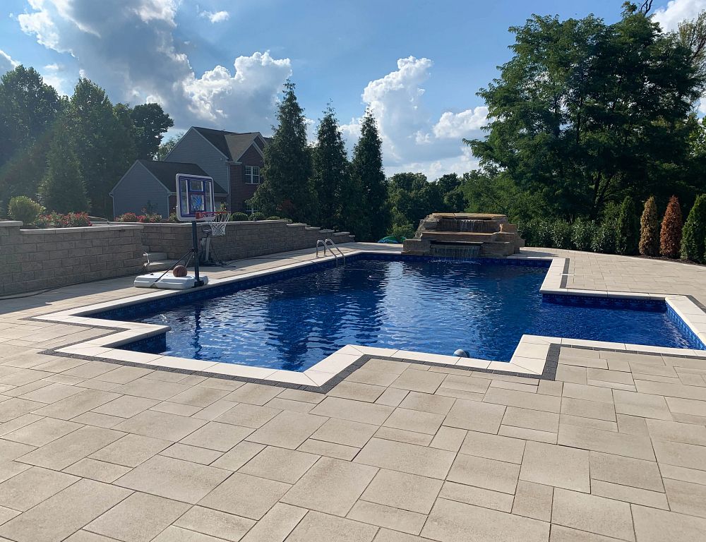 vinyl liner pool in Ohio backyard with custom shape and water feature