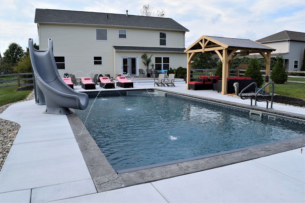 vinyl liner pool in Ohio backyard with waterslide and water features