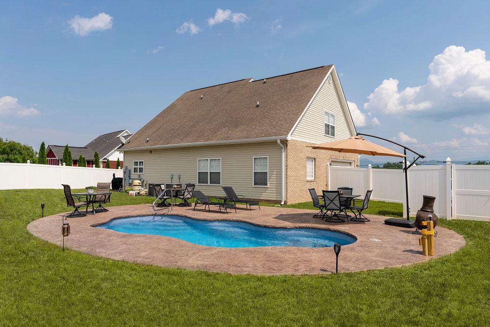 freeform fiberglass pool in small southern backyard