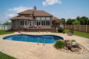 kidney-shaped fiberglass pool in large southern backyard