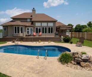 kidney-shaped fiberglass pool in large southern backyard