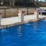 three raised fire bowls with waterfalls flowing into pool