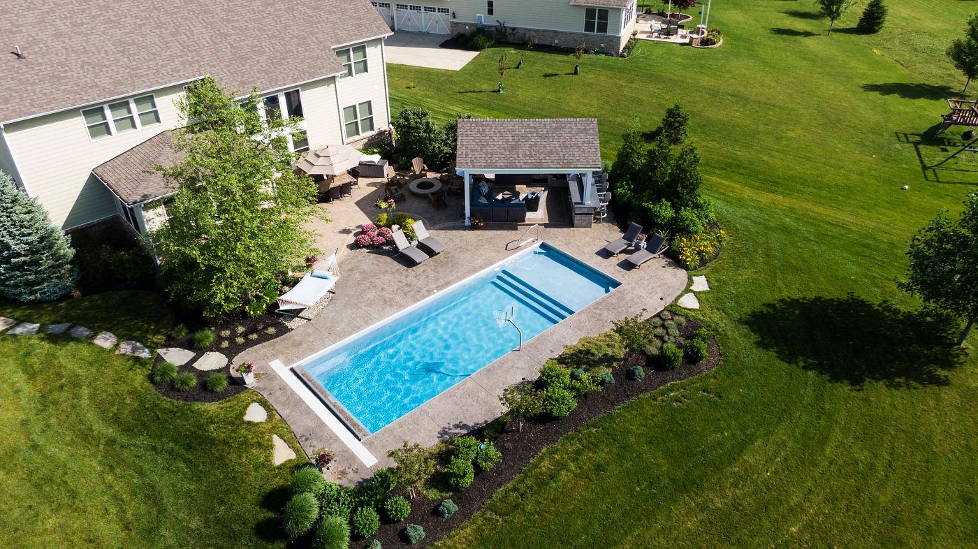 rectangular shaped fiberglass pool in large Indiana backyard