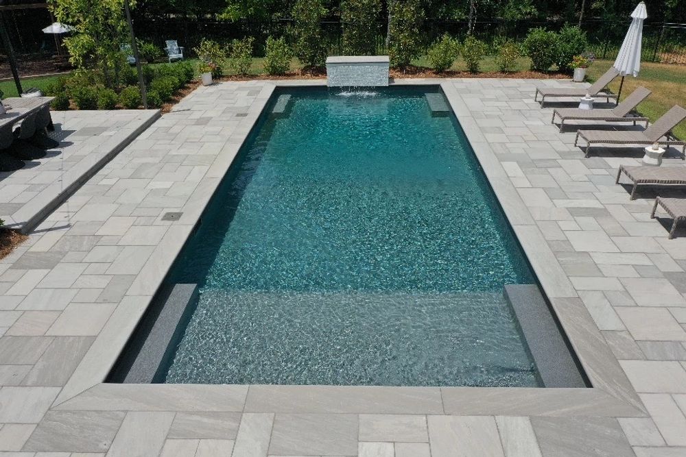 small rectangular vinyl liner pool in Tennessee backyard with custom water feature
