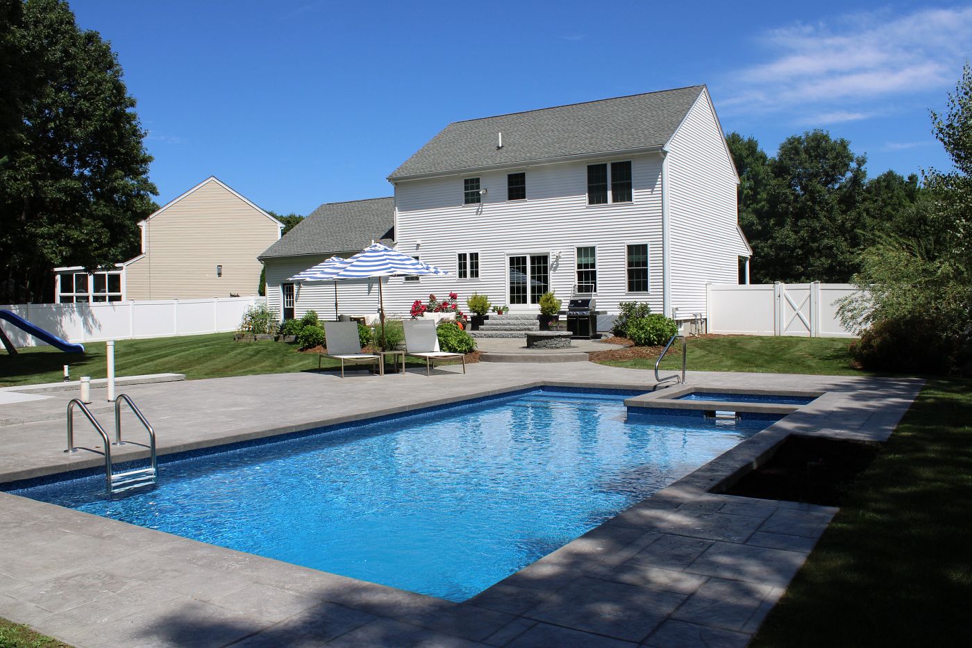 rectangular vinyl liner pool and spa in Massachusetts backyard