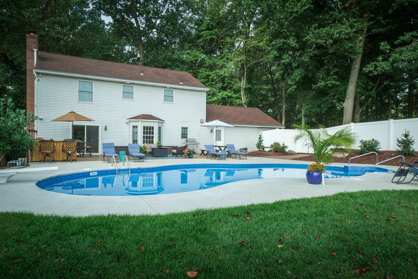 freeform vinyl liner pool in forested backyard