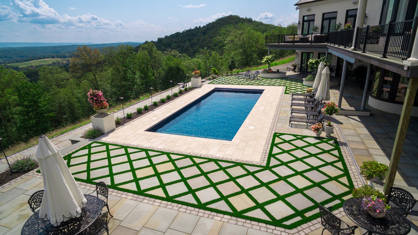 fiberglass pool built on a hill in a northeast backyard