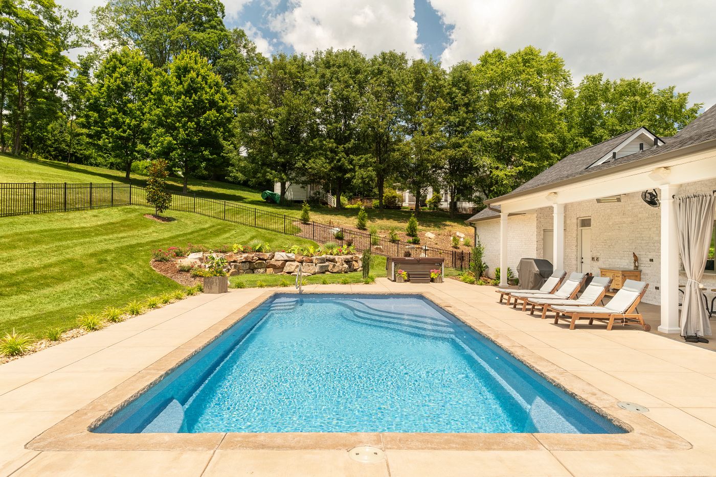 fiberglass pool in a smaller hillside, southern backyard