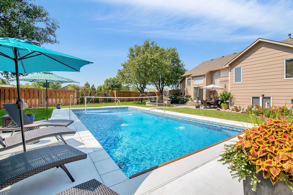 compact vinyl liner pool with custom water features in Kansas backyard
