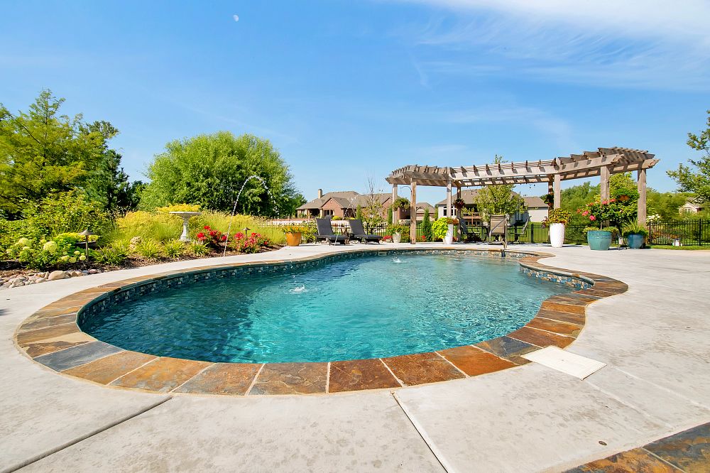large vinyl liner pool with custom water features in Kansas backyard