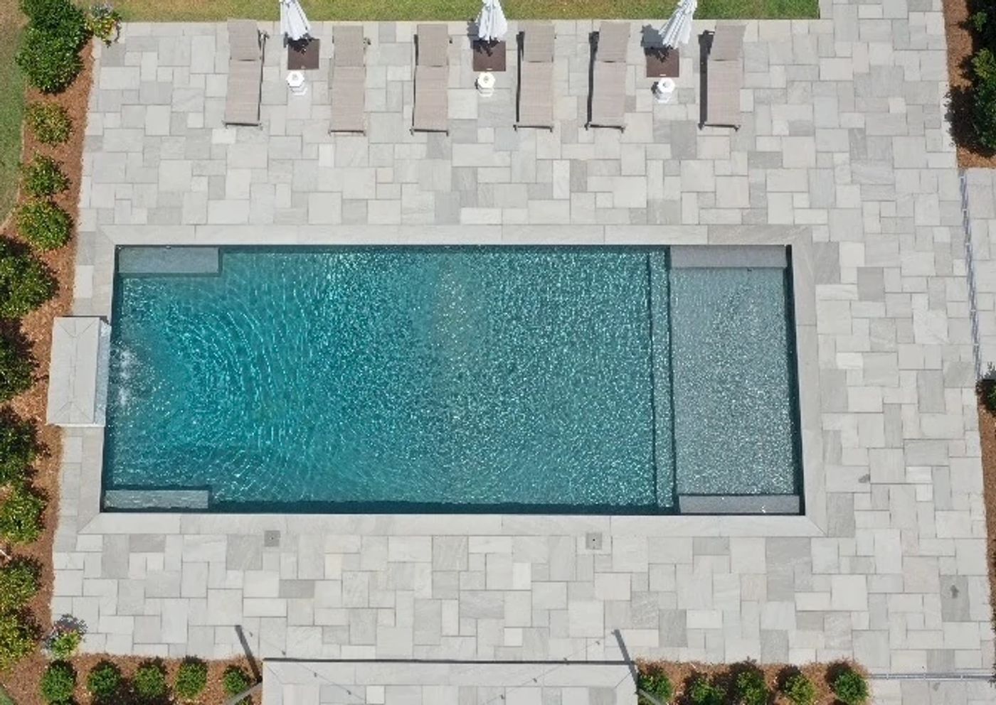 vinyl liner pool with custom water features in southern backyard