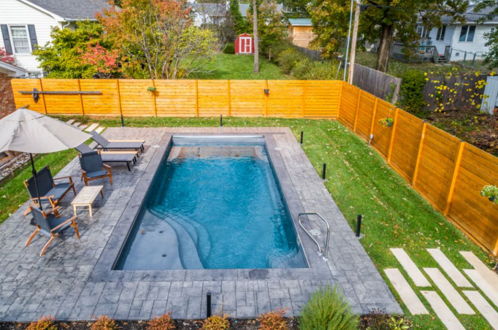 compact fiberglass pool in small southern backyard