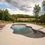 large freeform fiberglass pool in a spacious southern backyard