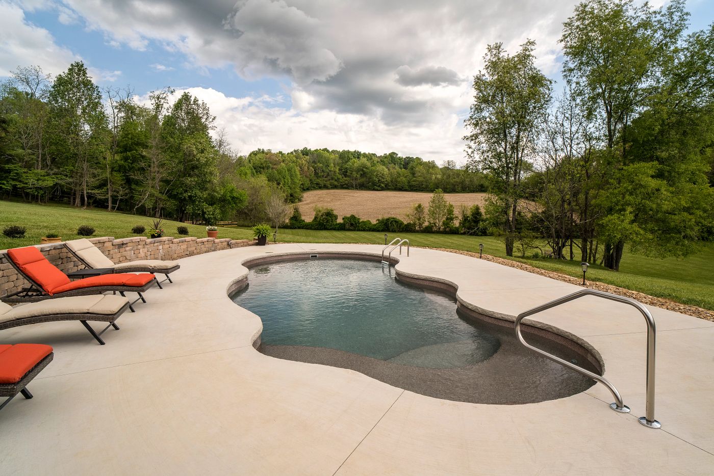 large freeform fiberglass pool in a spacious southern backyard