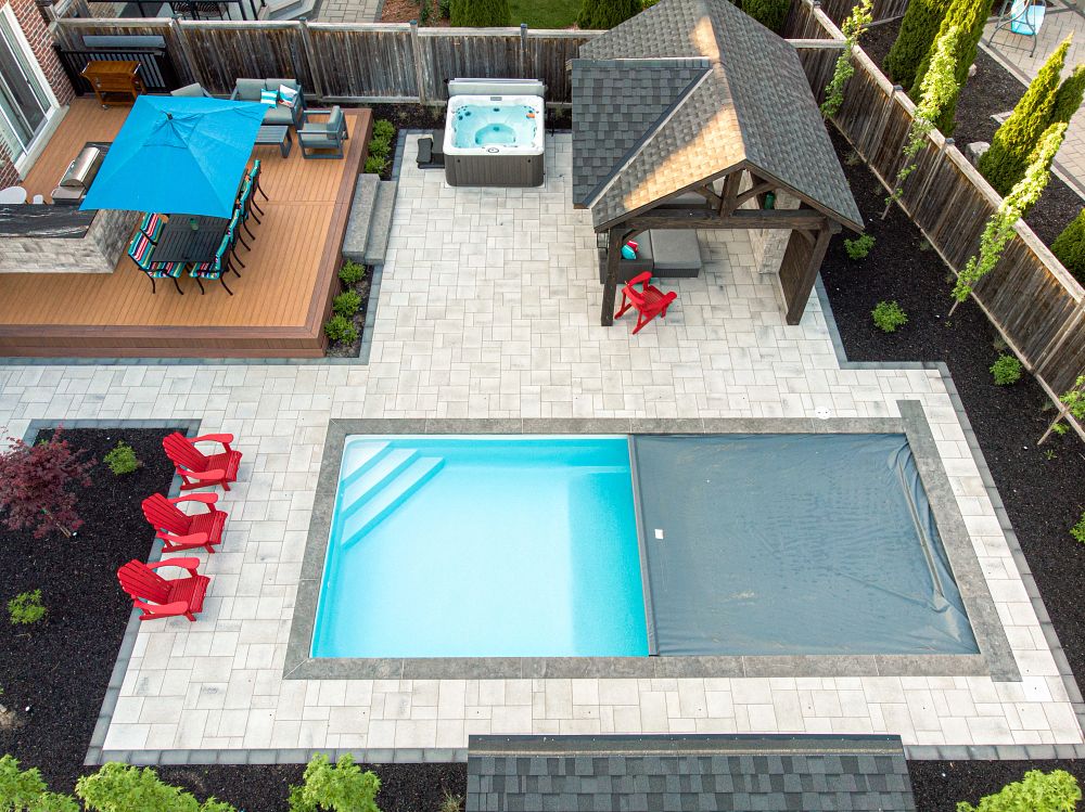 fibreglass pool with automatic safety cover closing in Canadian backyard