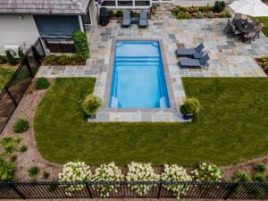 small fiberglass pool in little backyard
