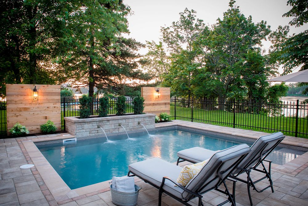 small vinyl liner pool with custom water features in Quebec backyard