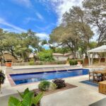 fiberglass pool with built-in spa and custom water features