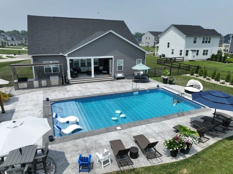large vinyl liner pool with swim up seating in suburban backyard