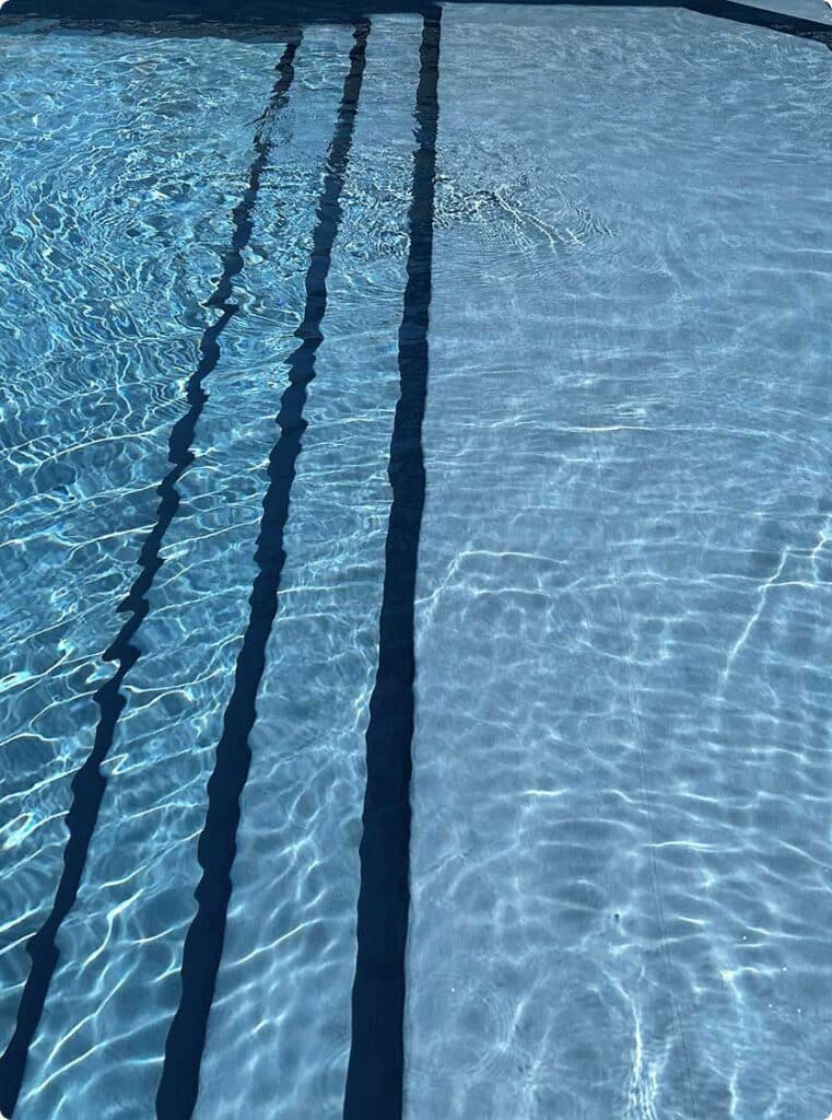 Vinyl liner pool with molded wide steps leading into shallow end.