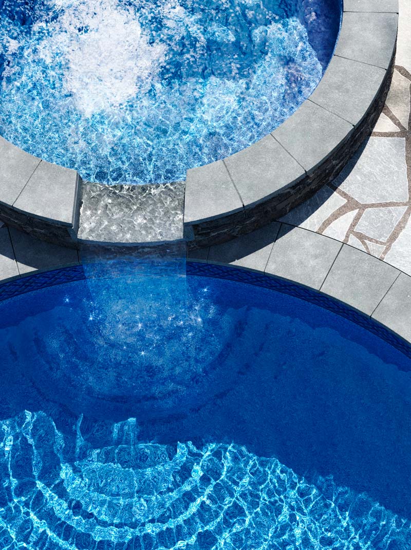 Tranquil overhead image of luxory pool and spa with lounge chairs