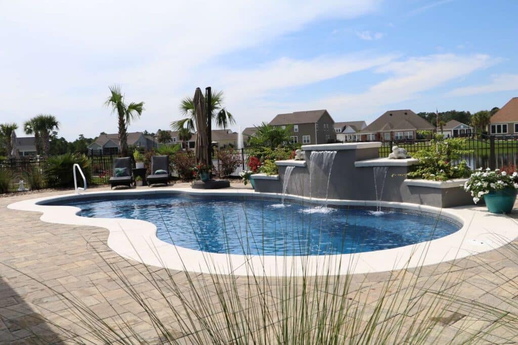 freeform inground fiberglass pool with waterfall feature